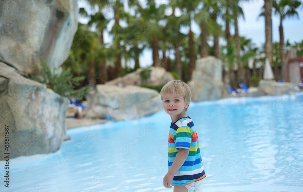 Little baby boy near swimming pool