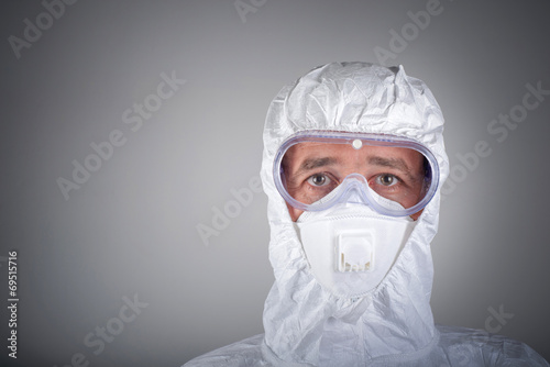 Scientist in protective wear, glasses, respirator photo