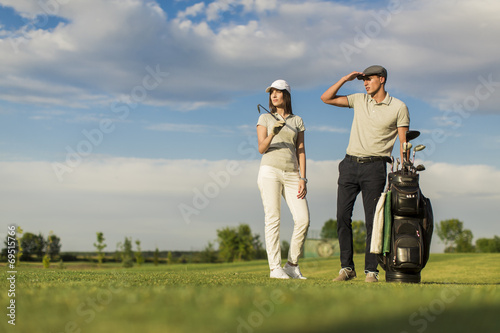 Young couple playing golf