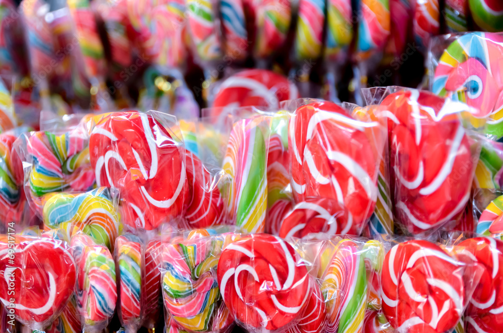Colorful spiral lollipop isolated on a colored background