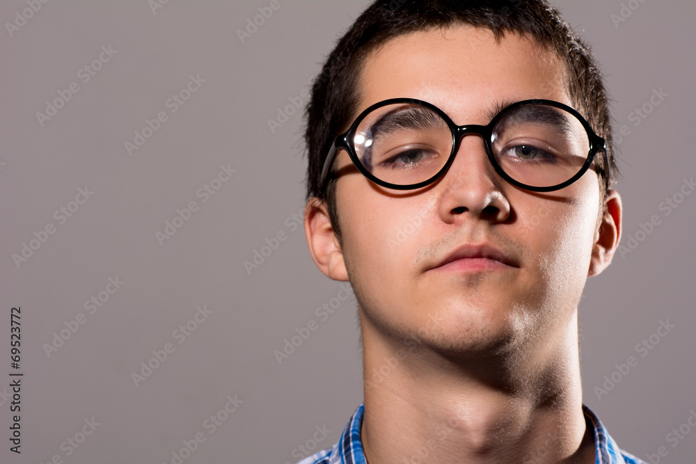 Close-up portrait Man in glasses with a serious expression on hi Close-up portrait Man in glasses with a serious expression on hi