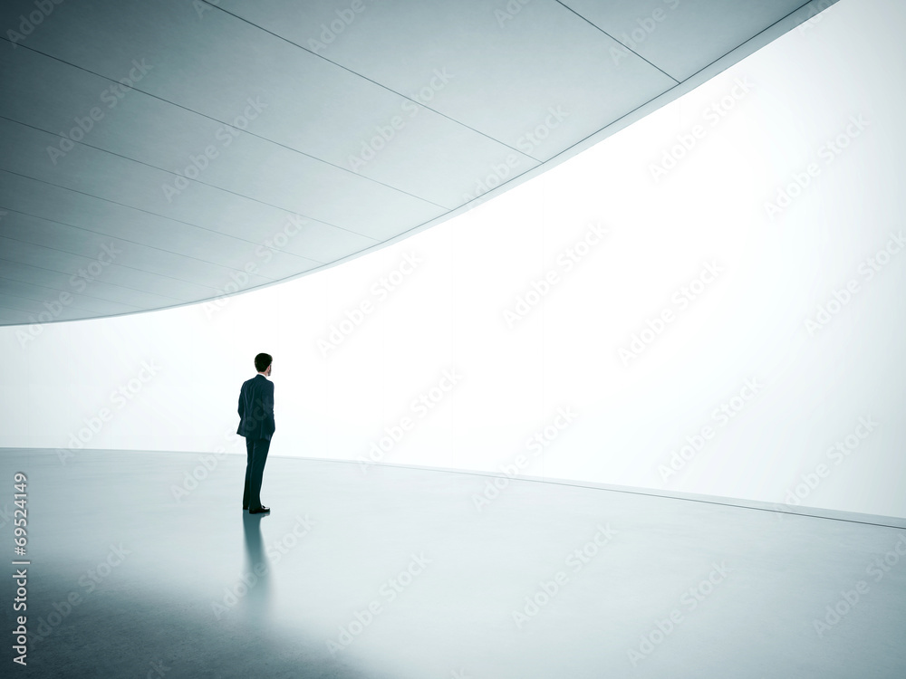 Businessman looking at wide shining screen Businessman looking at wide shining screen