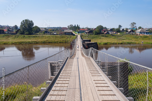 Fototapeta Naklejka Na Ścianę i Meble -  Old suspension bridge over the River Tura