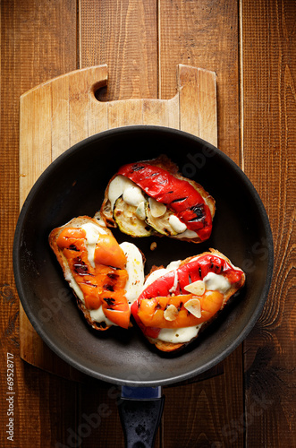 Bruschetta with roasted bell pepper and mozzarella cheese photo