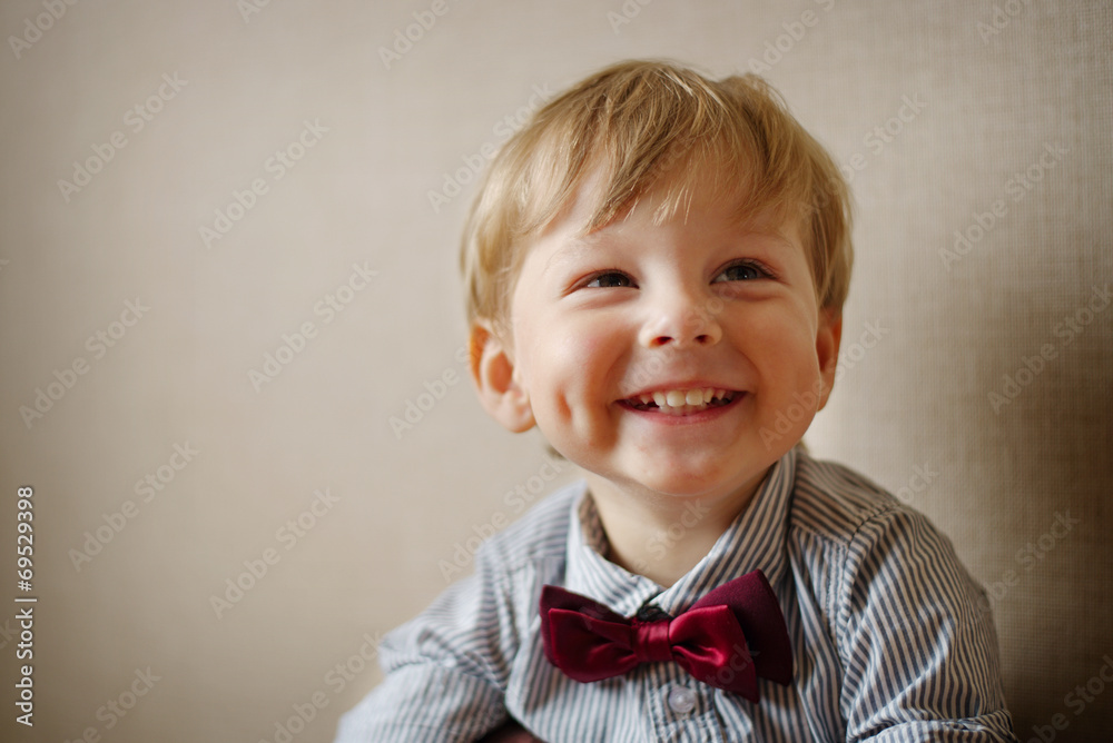 Young Boy Wearing Bow Tie Smiling and Looking Up Young Boy Wearing Bow Tie Smiling and Looking Up