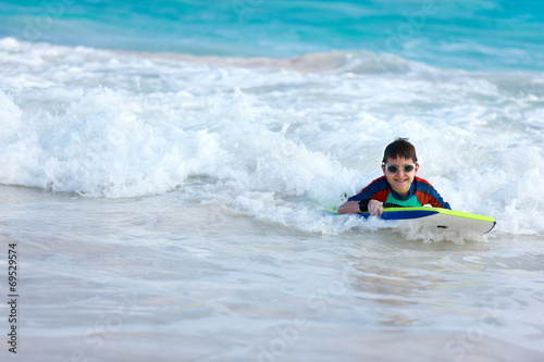 Boy swimming on boogie board © BlueOrange Studio