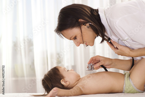 Beautiful doctor with little girl