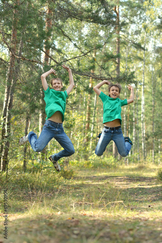 Two teenage brothers jumping