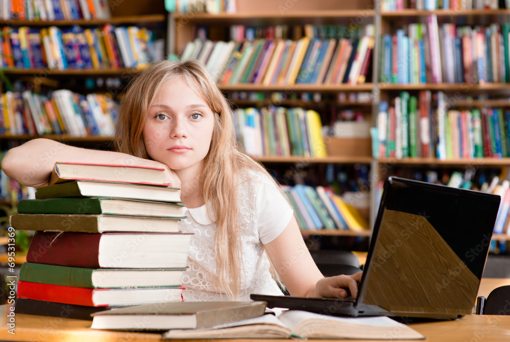 Portrait of a pretty female student in library Portrait of a pretty female student in library