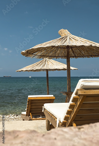 Fototapeta Naklejka Na Ścianę i Meble -  Chairs and umbrella on a beach.
