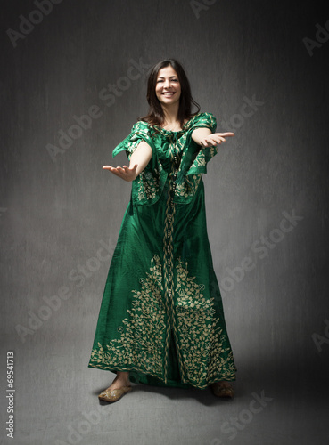 girl with traditional arab dress dancing