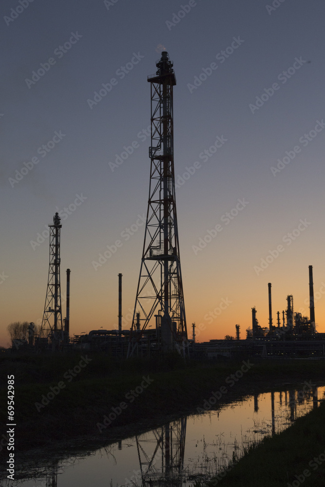 An oil refinery at sunset