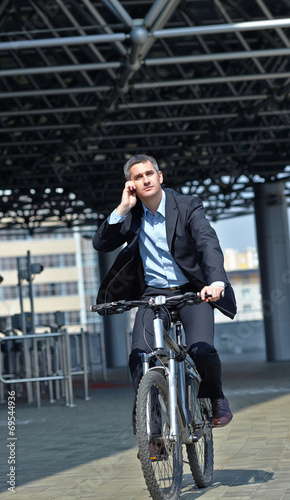 active businessman riding a bicycle on the way to job