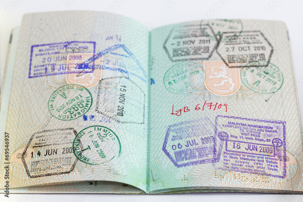 Closeup of an open passport with many stamps