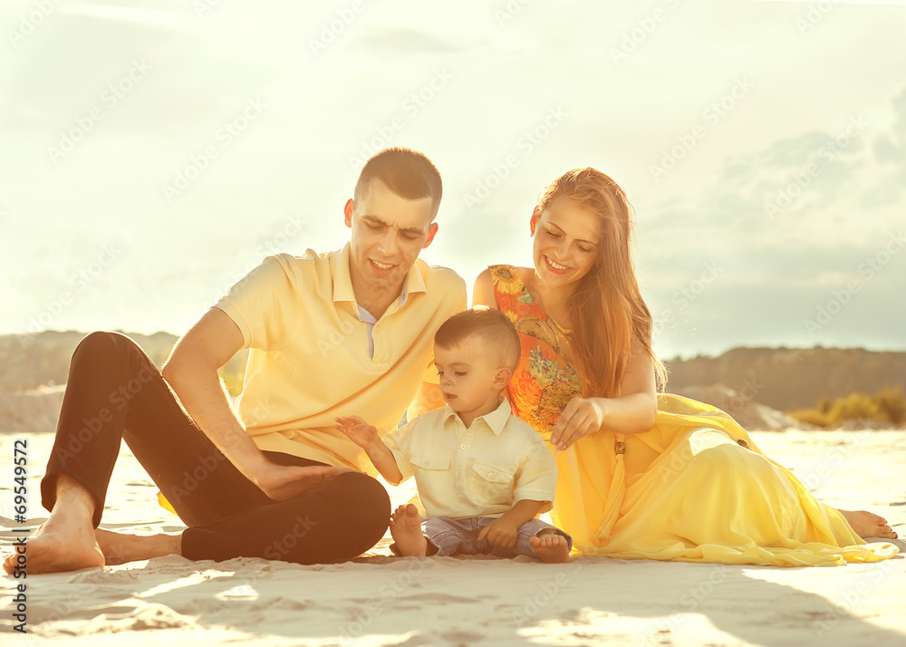 Happy beautiful family on the beach sunset Happy beautiful family on the beach sunset