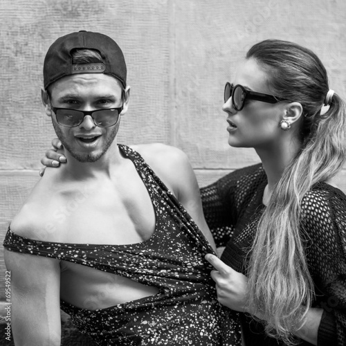 Sexy and fashionable couple wearing jeans, sunglasses. Vogue