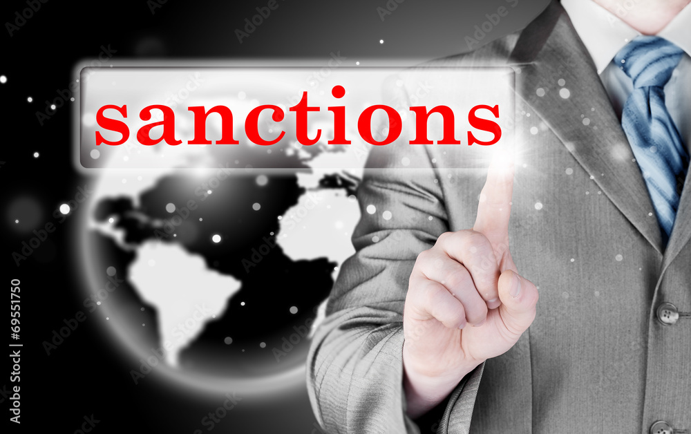 businessman pressing sanctions button on virtual screens businessman pressing sanctions button on virtual screens