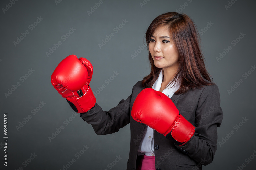 Asian businesswoman with boxing glove