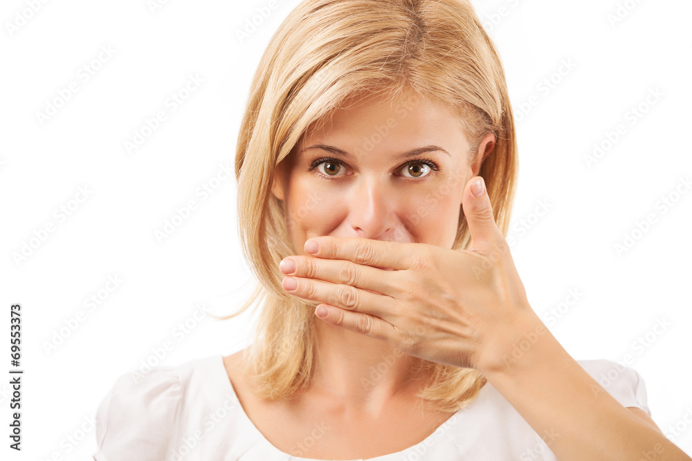 Smiling young woman covering mouth over background Smiling young woman covering mouth over background