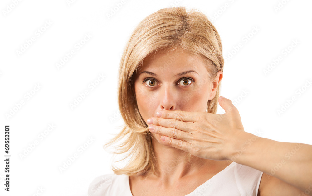 Amazed young woman covering mouth over background Amazed young woman covering mouth over background
