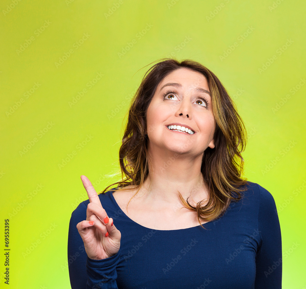 Woman came up with idea aha index finger pointing looking up Woman came up with idea aha index finger pointing looking up