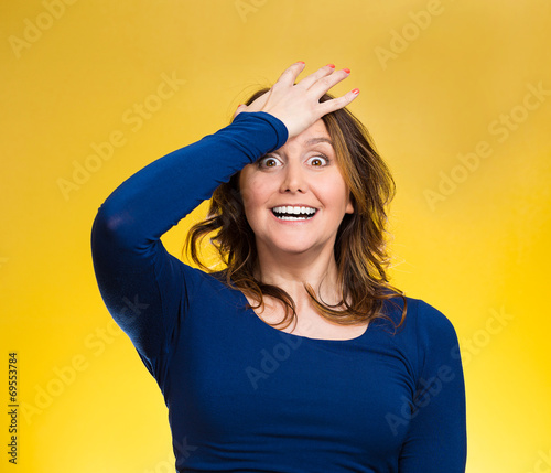 Woman placing hand on head palm on face gesture in duh moment