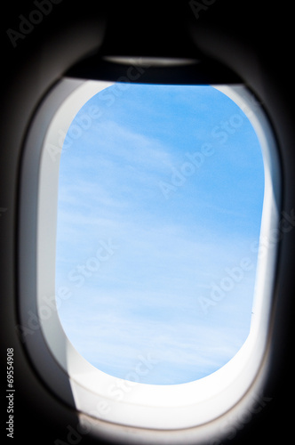 view from the window of an airplane flying in the clouds