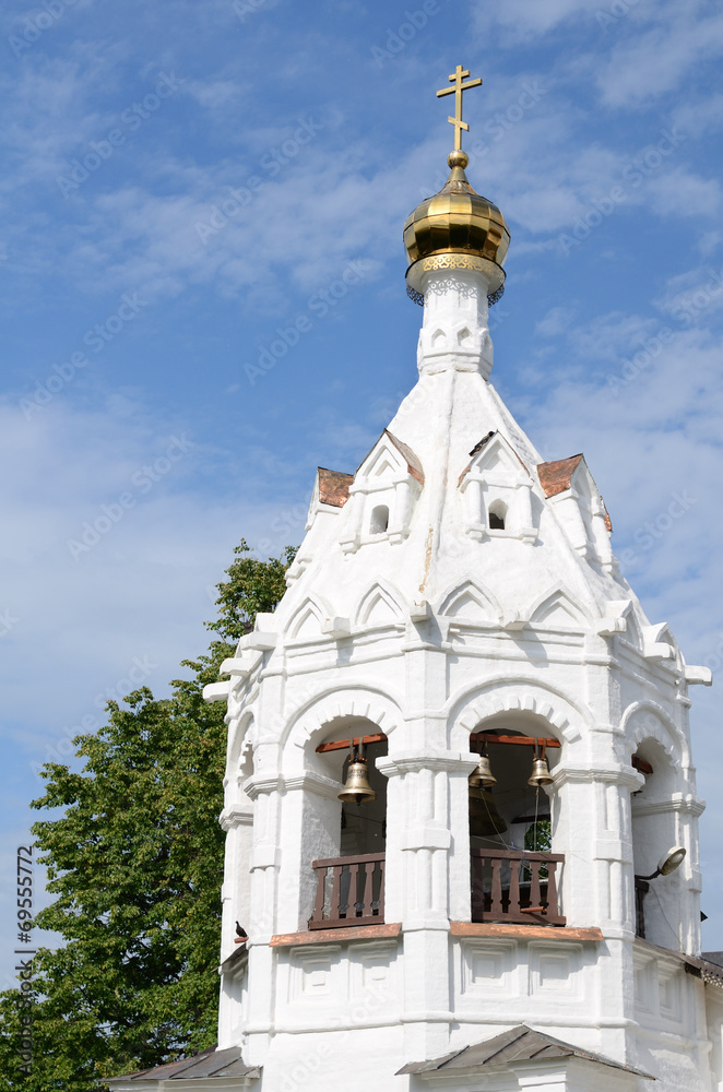 White orthodox church against blue sky with white clouds