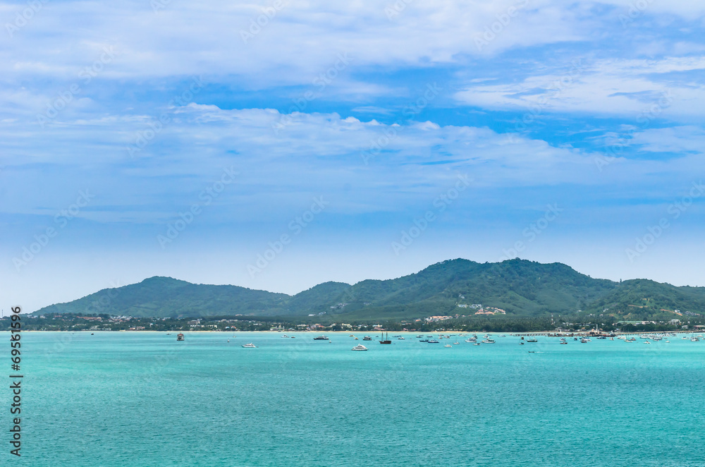 boat in a bay with green sea and blue sky (at chalong bay, phuke