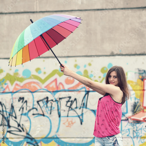 girl with a rainbow umbrella on the roof 