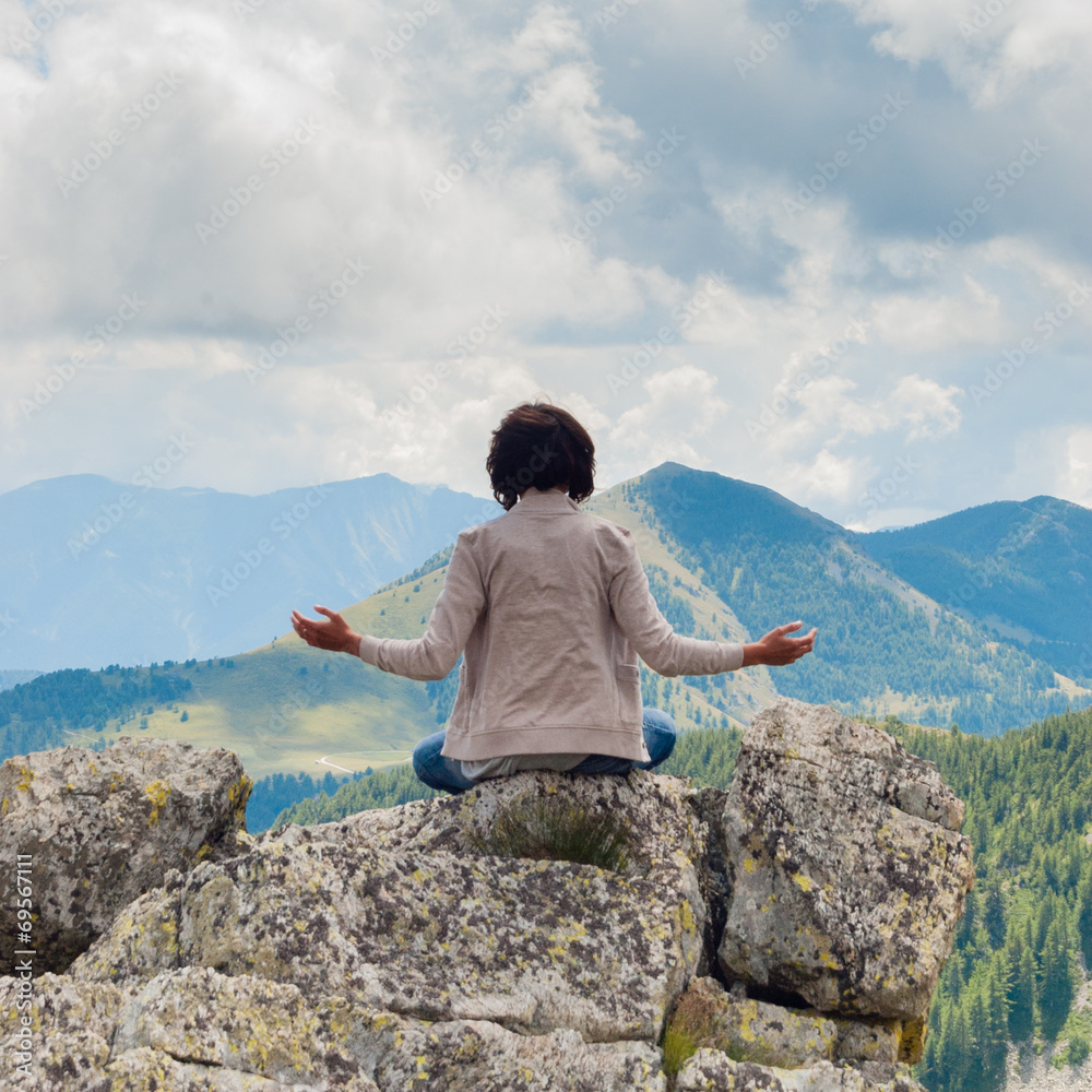 Girl in meditation on Dolomiti - Italy
