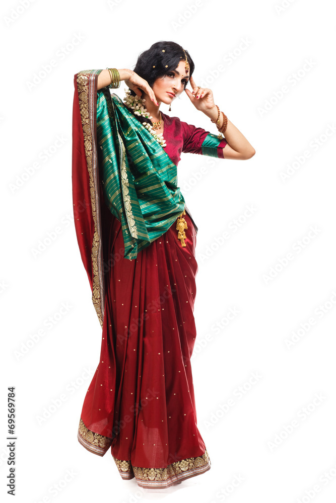 Fototapeta premium Beautiful young indian woman in traditional clothing, isolated