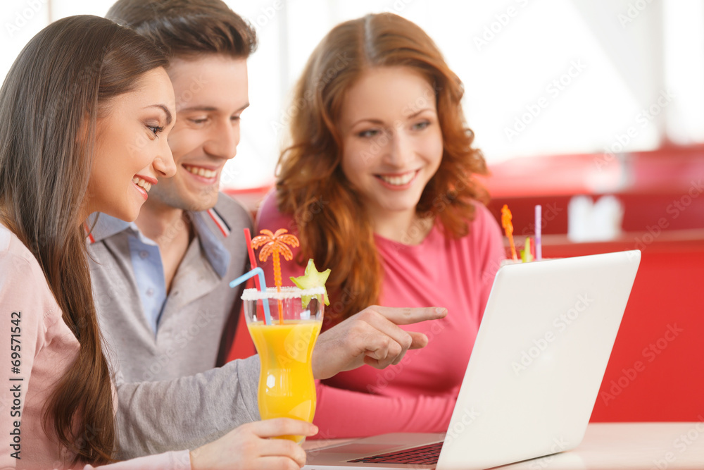 side view of three students using laptop. side view of three students using laptop.