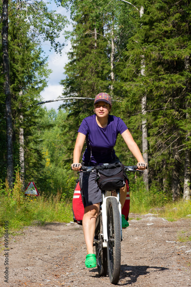 Fototapeta premium girl on the bicycle in the forest