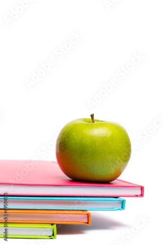 Green apple on notebooks