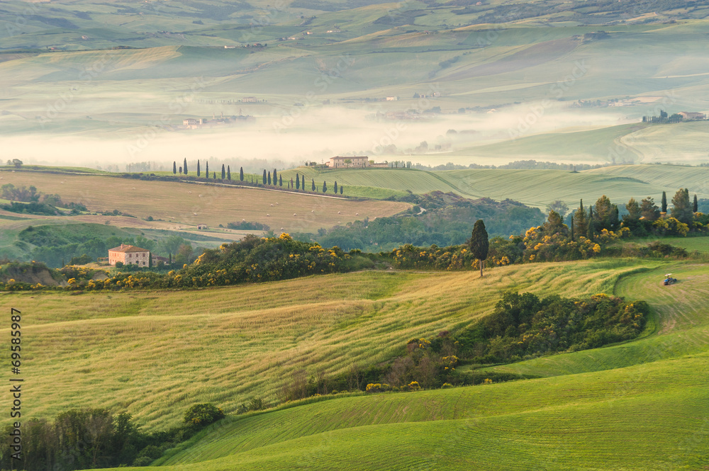 Tuscan landscape at sunrise in silence and colors of peace
