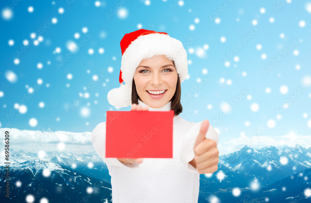 woman in santa helper hat with blank red card woman in santa helper hat with blank red card