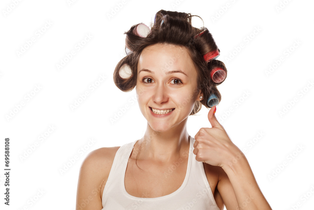 happy woman with hair curlers showing thumb up happy woman with hair curlers showing thumb up