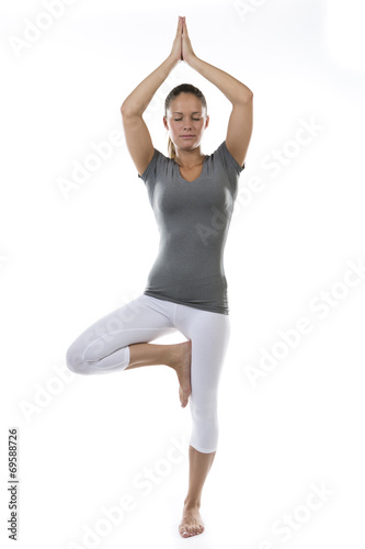 Serene young woman practising yoga