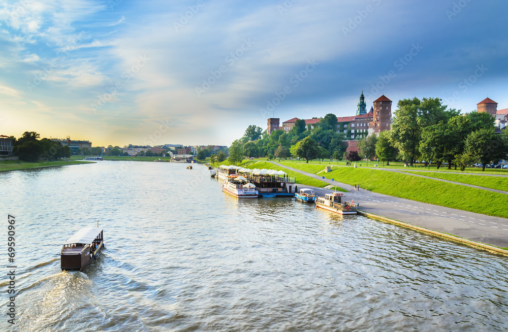 Fototapeta premium Tourist boats on Vistula river with Wawel Royal Castle, Poland