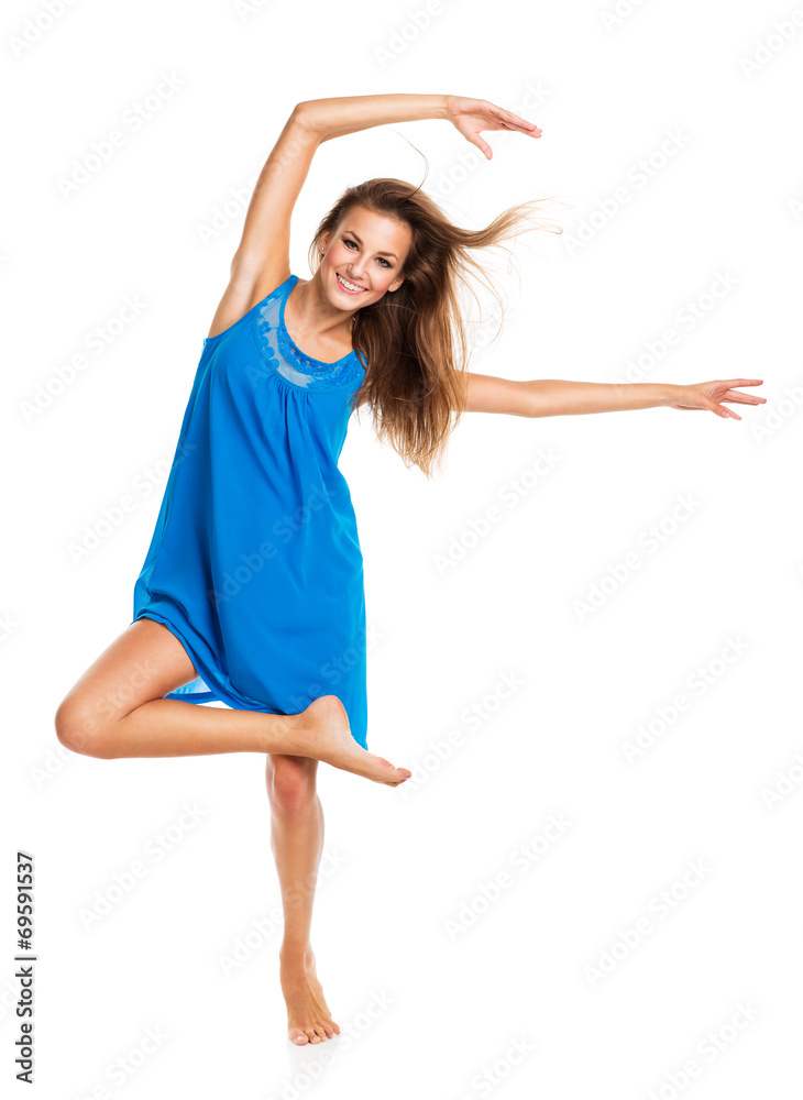 Fototapeta premium Young girl dancing in a blue dress