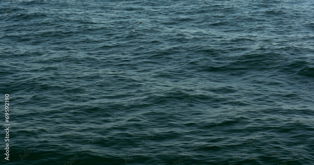 Flying over the ocean, waves forming, sparkles and wakes Flying over the ocean, waves forming, sparkles and wakes