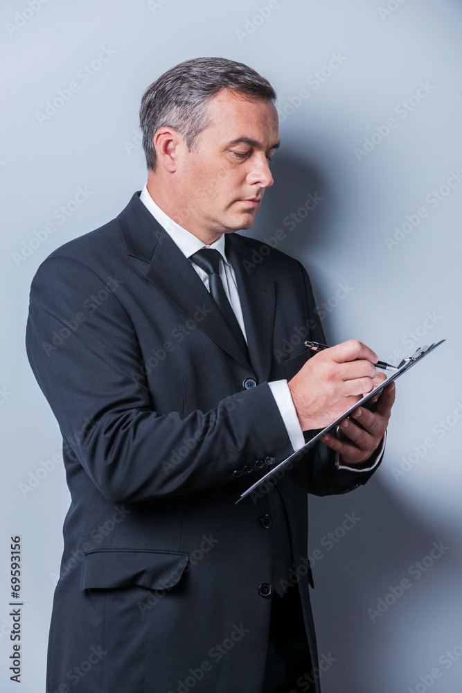 Businessman making notes. Businessman making notes.