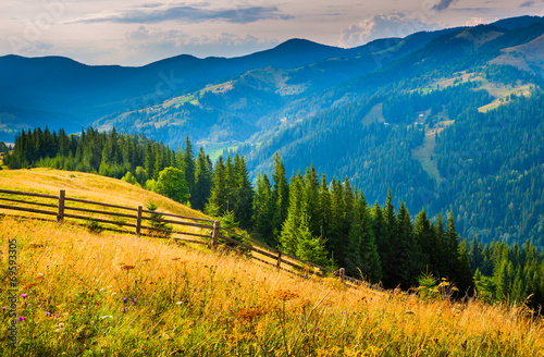 Amazing mountain landscape with fog and a haystack