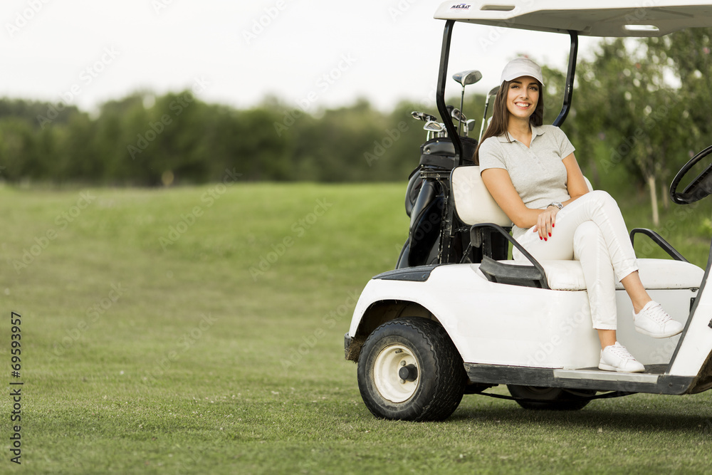 Young woman at golf cart