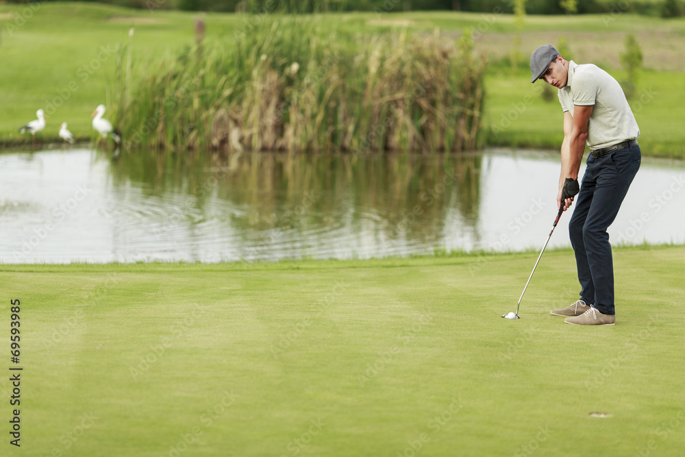 Fototapeta premium Young man playing golf