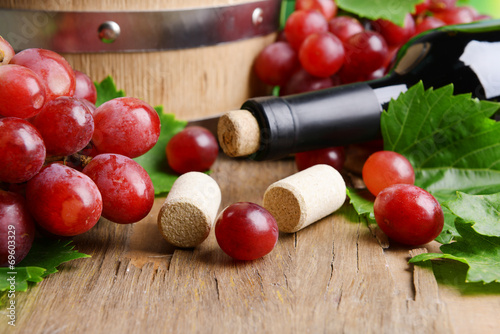 Wine bottle corks with grapes on table close-up