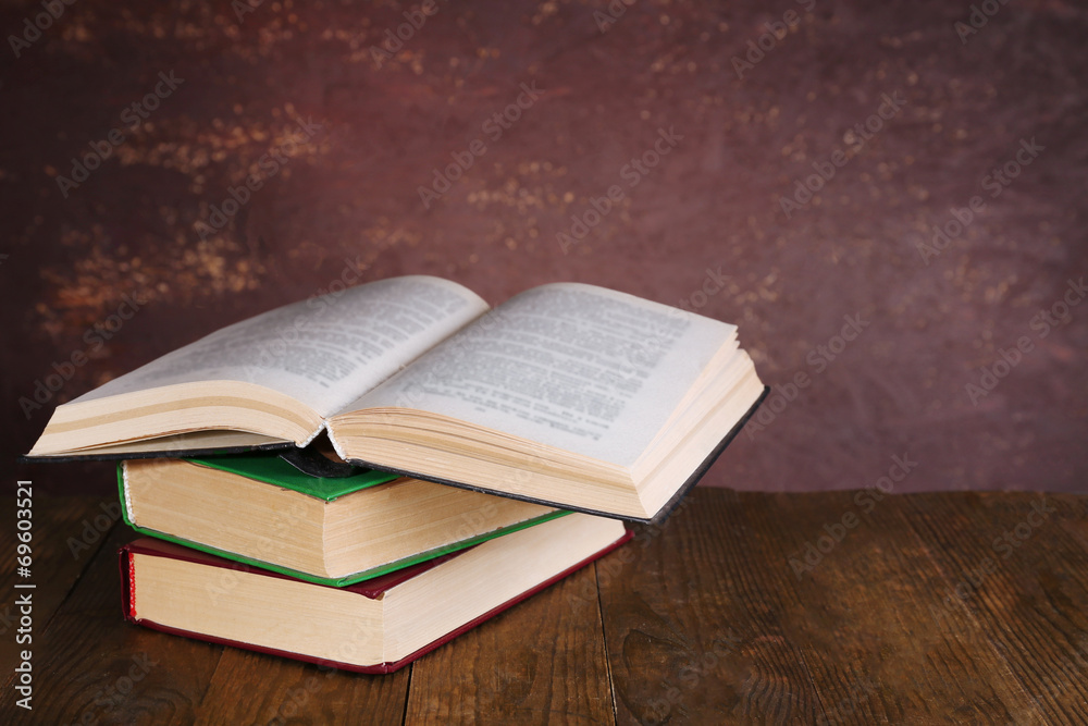 Fototapeta premium Books on wooden table on dark background