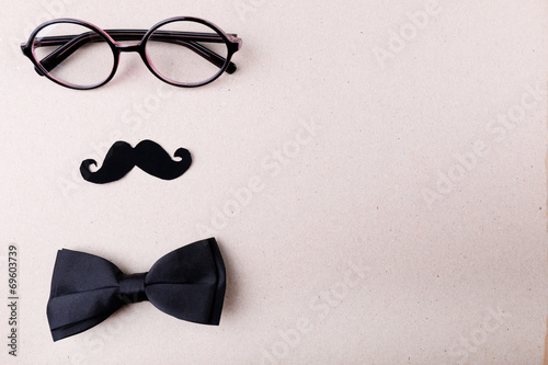 Glasses, mustache and bow tie forming man face