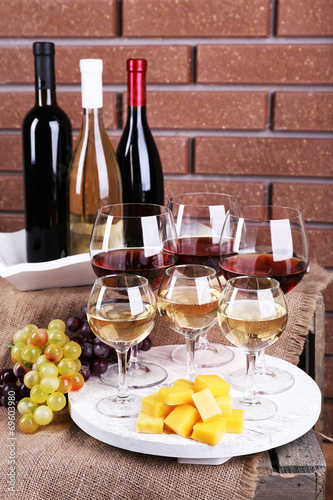 Fototapeta Naklejka Na Ścianę i Meble -  Bottles and glasses of wine, cheese and ripe grapes